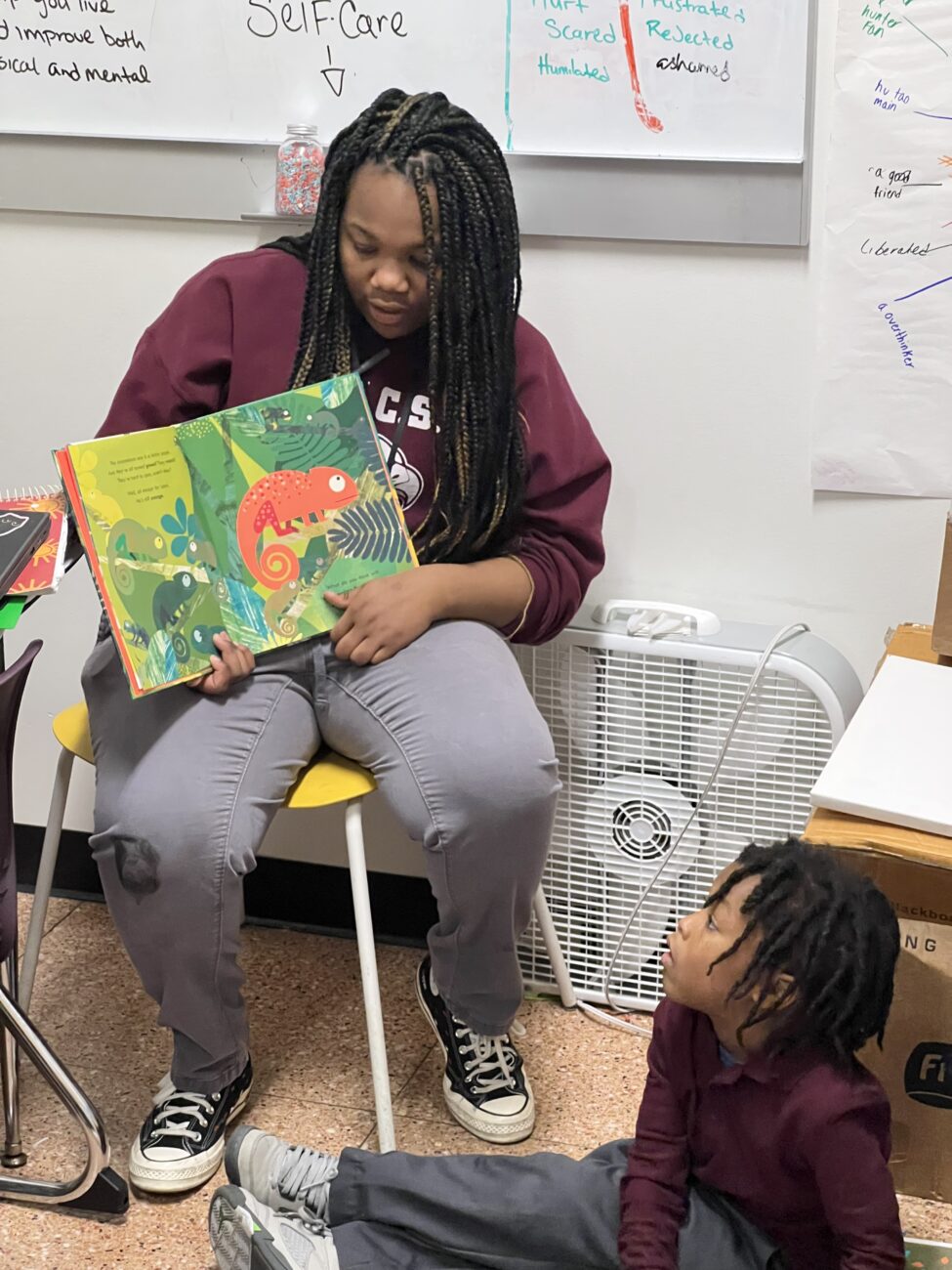 Student reads to kindergartener