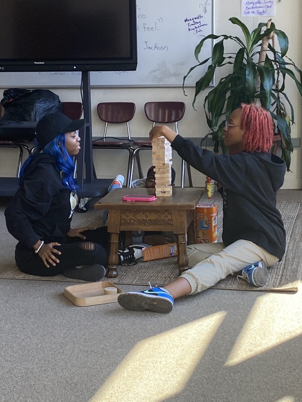 Two high school students play Jenga