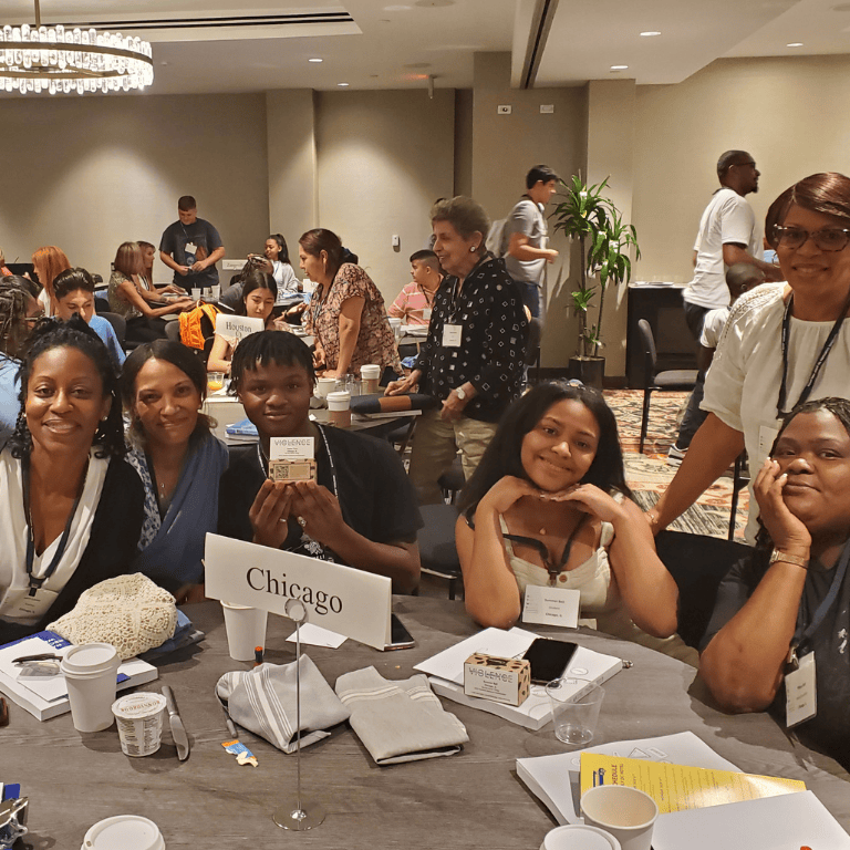 Chicago ambassadors sit at table with family and educators