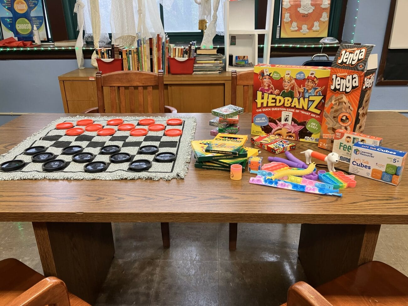 Checkers, Hedbanz, and other games displayed on table