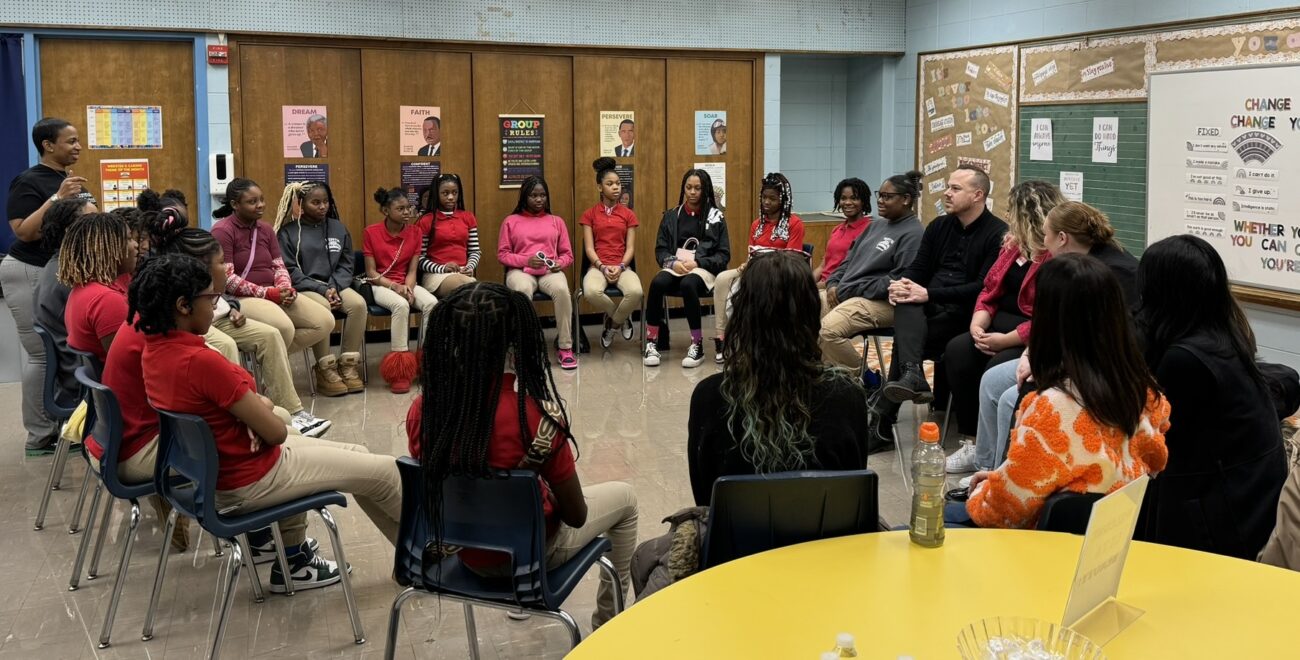 Students sit in circle with Ulta team