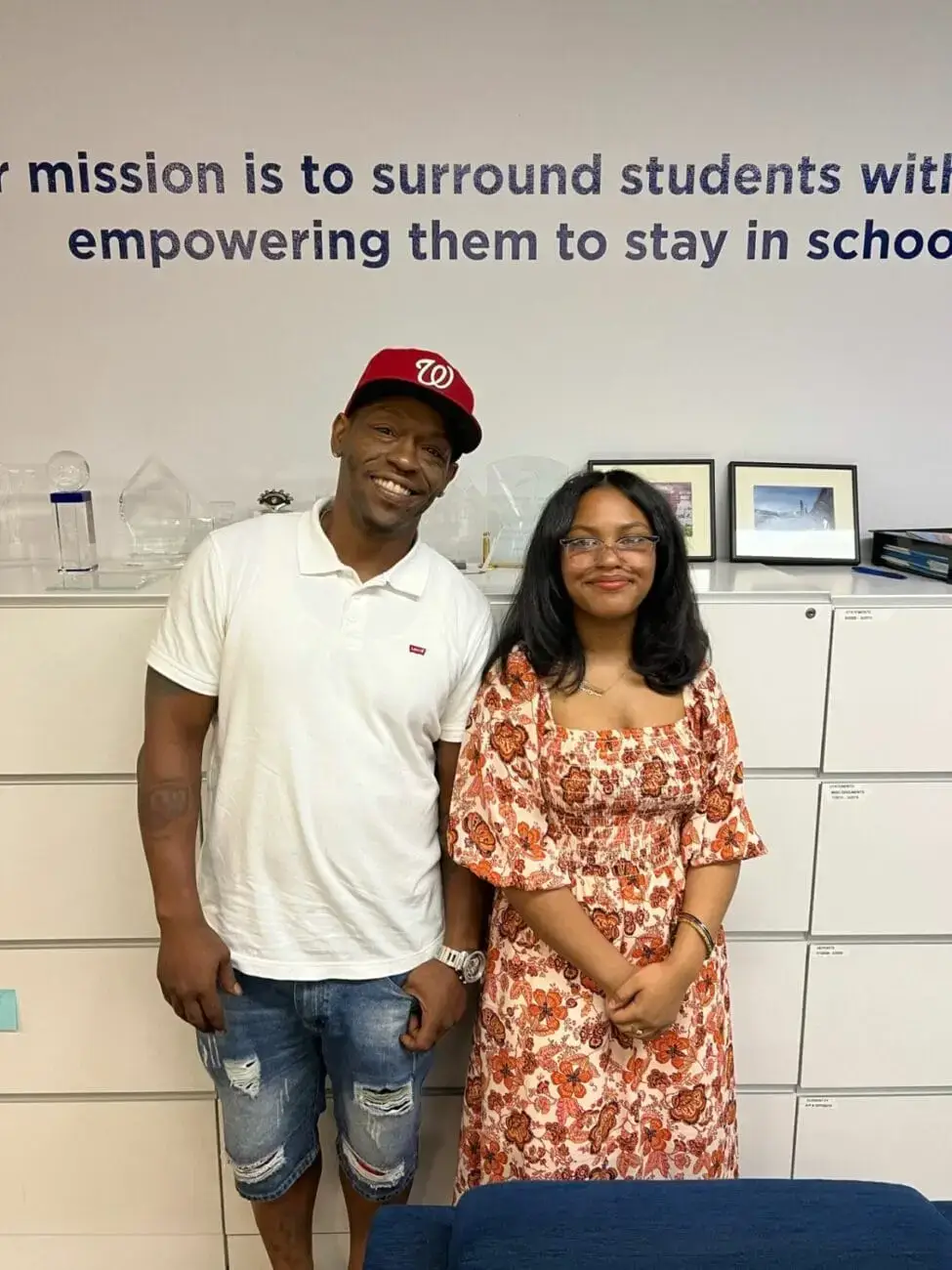 Student poses with father at CIS headquarters