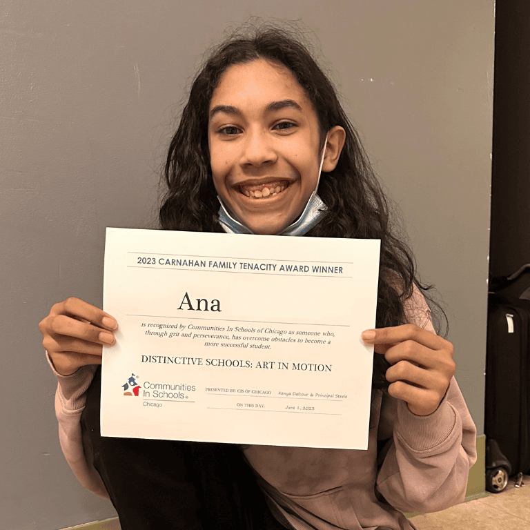 Student holds Tenacity Award winner certificate