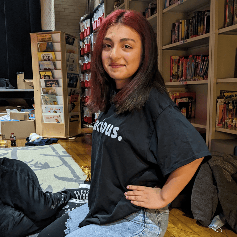 Student poses with "tenacious" T-shirt