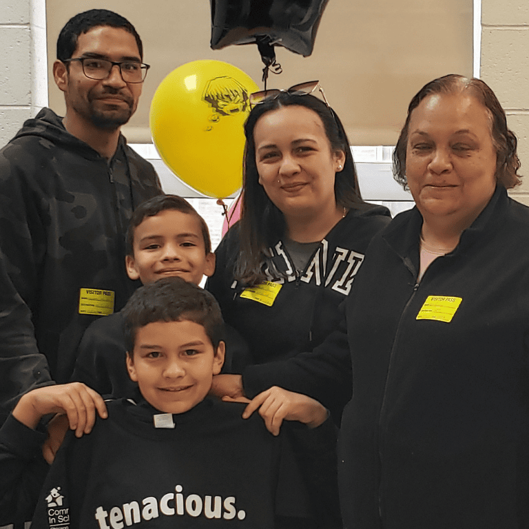 Student poses with family after receiving award