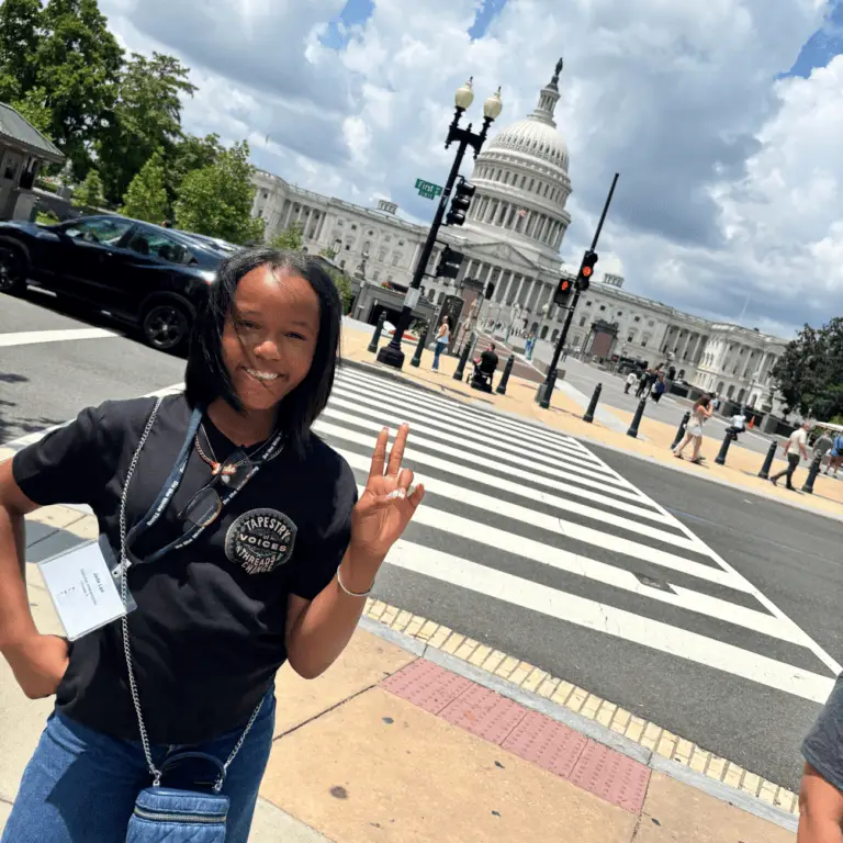 Jade stands next to capitol building
