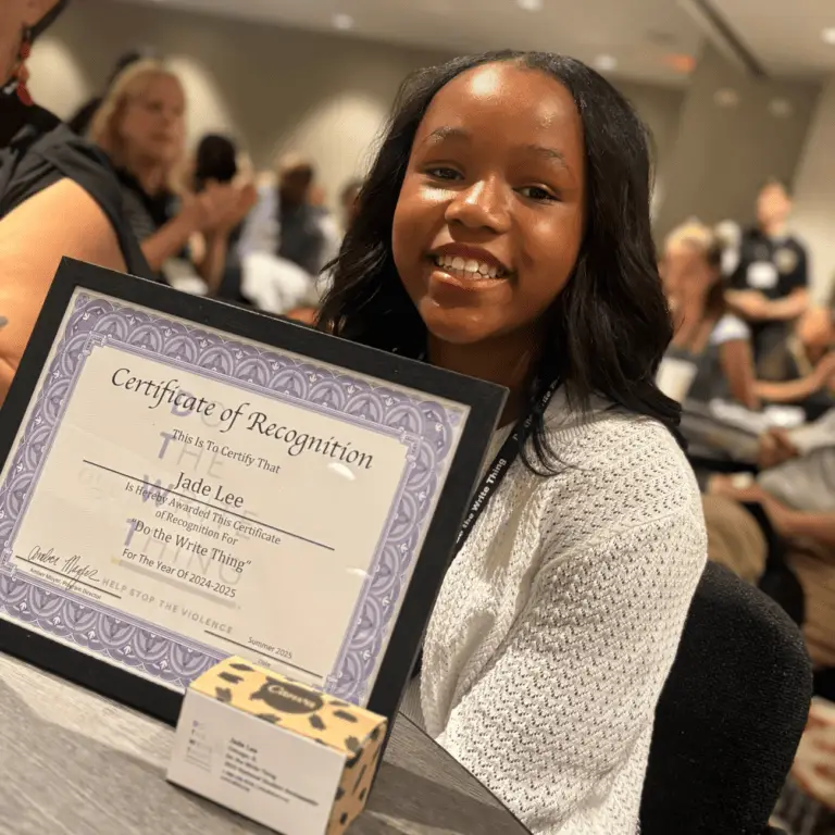 Jade holds Do the Write Thing certificate